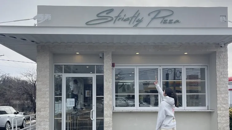 The Strictly Pizza storefront on Boston Post Road, script sign above the awning